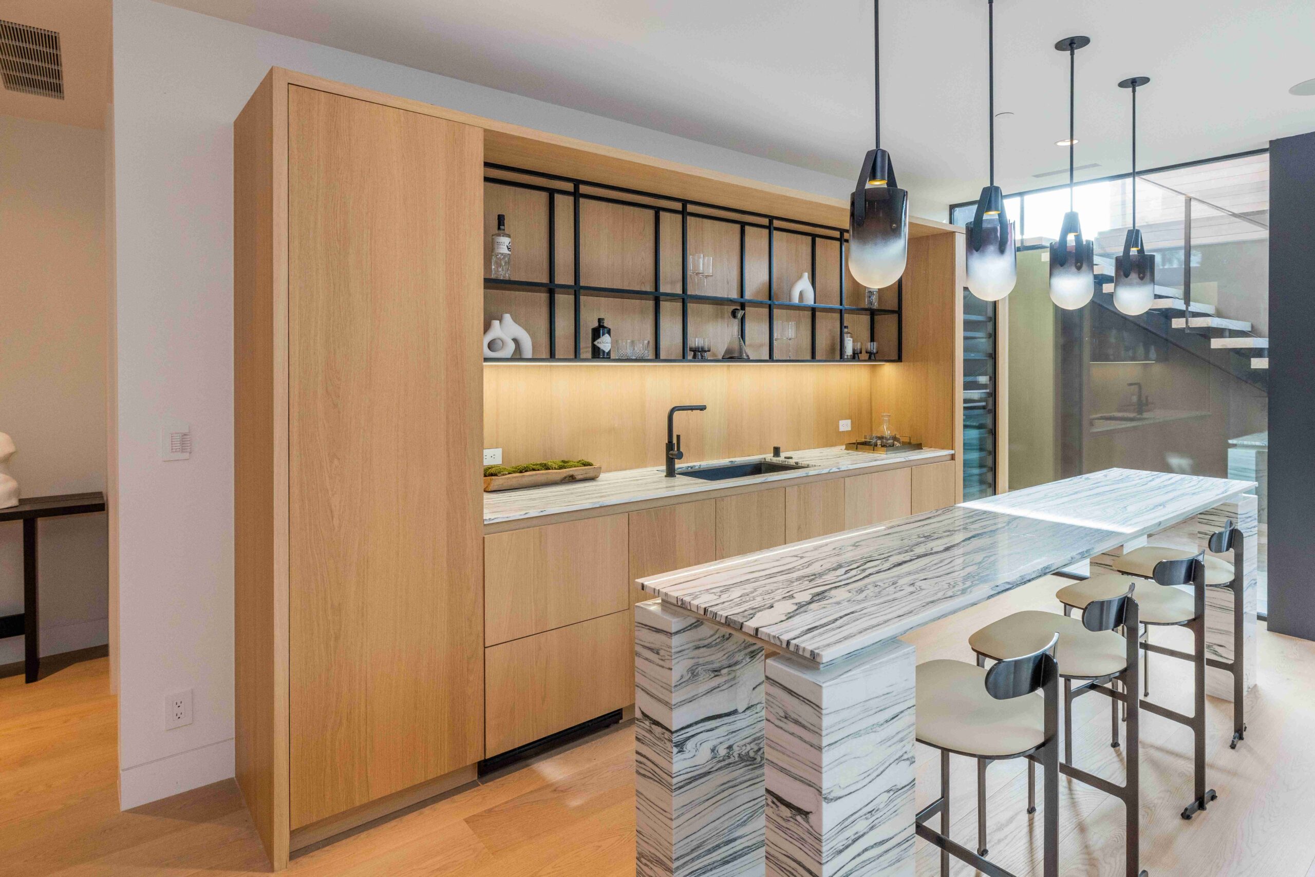 modern bar kitchen custom cabinetry marble countertop integrated appliances